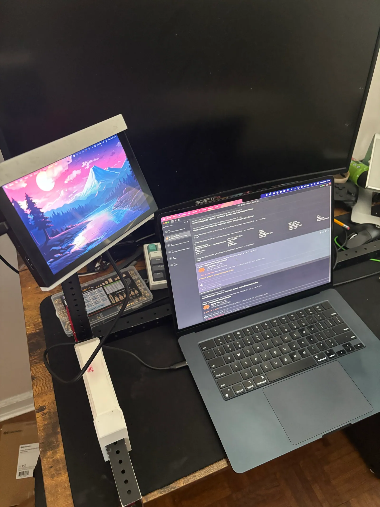 The 7-inch screen in its 3D printed mount, next to the laptop